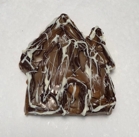 A caramel house drizzled with white and dark chocolate