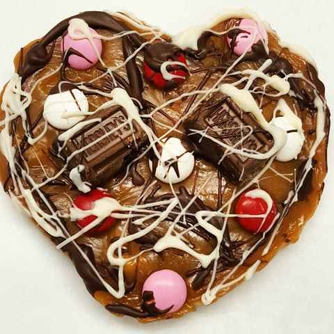 Heart shaped pizza made of from scratch caramel drizzled with chocolate